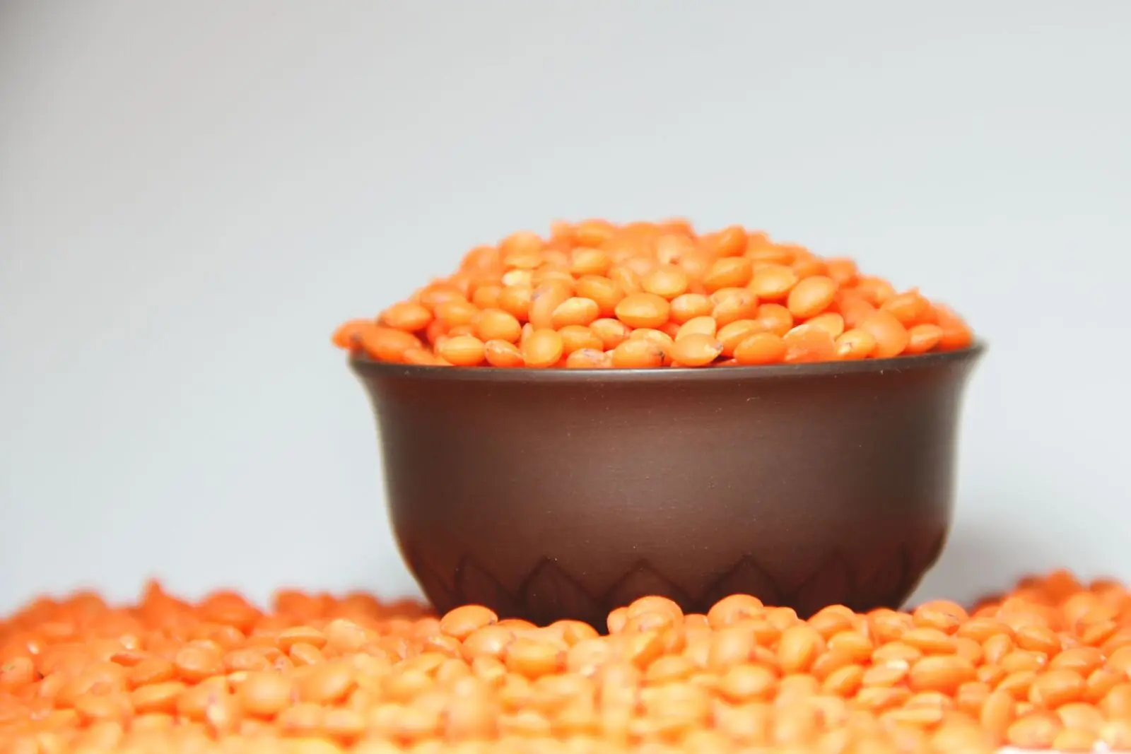 A bowl heaped with dry red lentils